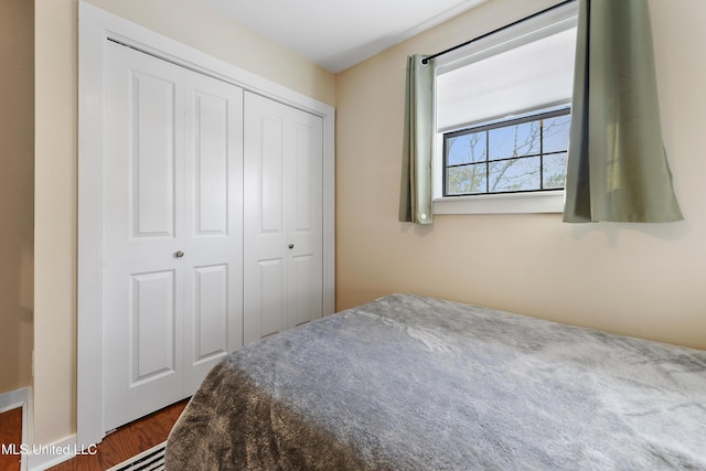 bedroom with a closet and dark hardwood / wood-style floors