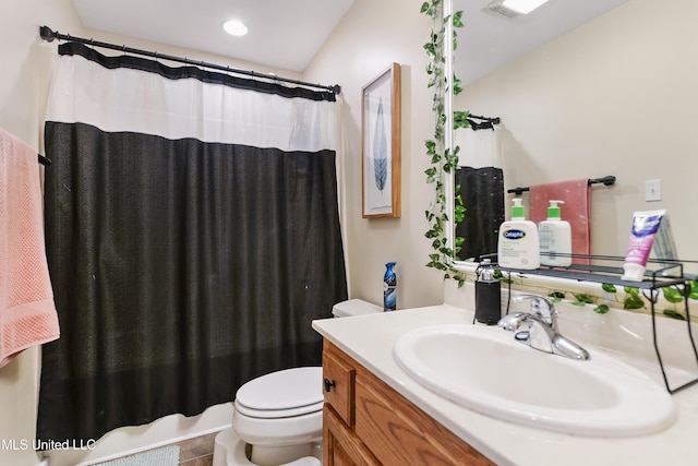 bathroom featuring walk in shower, vanity, and toilet