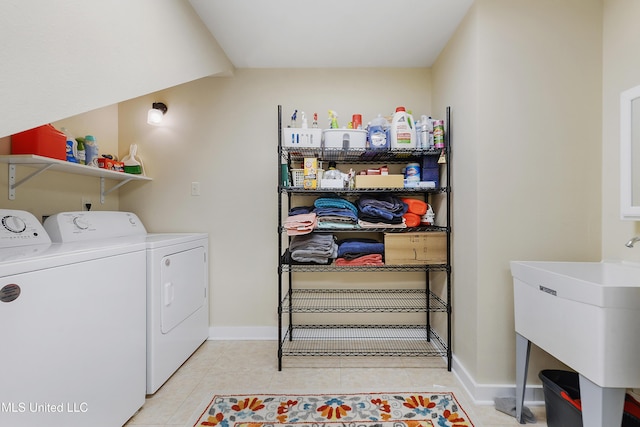 laundry room with separate washer and dryer, sink, and light tile patterned flooring