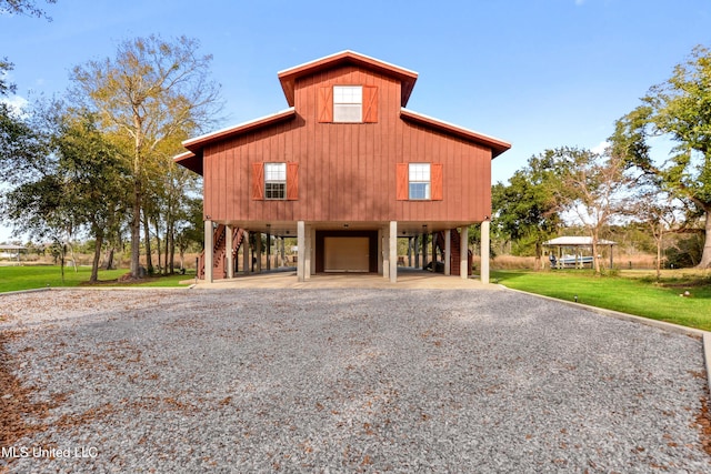 exterior space featuring a carport and a front lawn