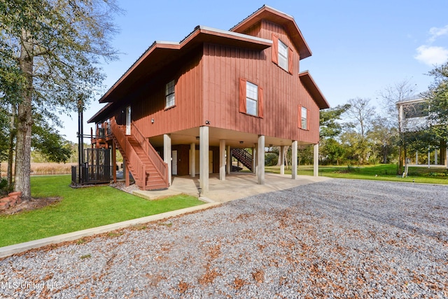 exterior space featuring a yard and a carport