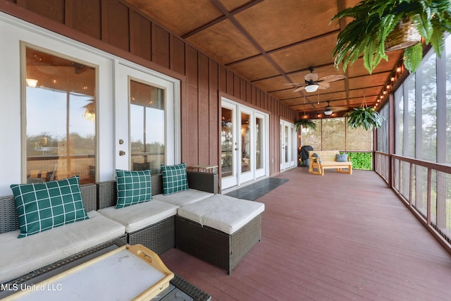 sunroom / solarium featuring wooden ceiling, ceiling fan, and a healthy amount of sunlight