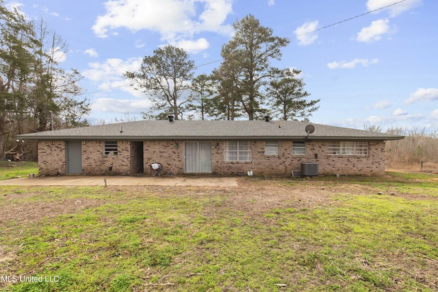 back of house with central air condition unit, a patio area, and a lawn