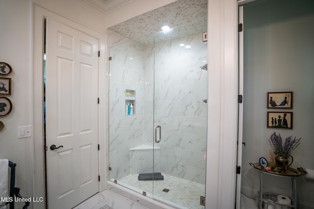 bathroom featuring a shower with shower door and crown molding