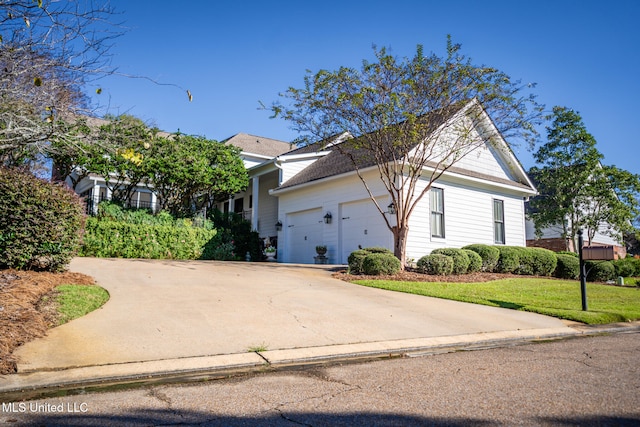 view of side of property with a garage and a yard