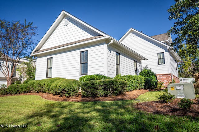 view of side of home featuring a yard