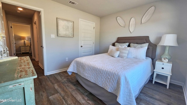 bedroom featuring dark wood-type flooring, baseboards, and visible vents