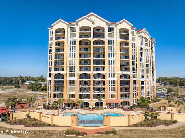 view of building exterior with a community pool