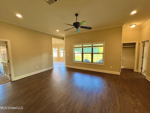 interior space featuring ceiling fan with notable chandelier, dark hardwood / wood-style flooring, and crown molding