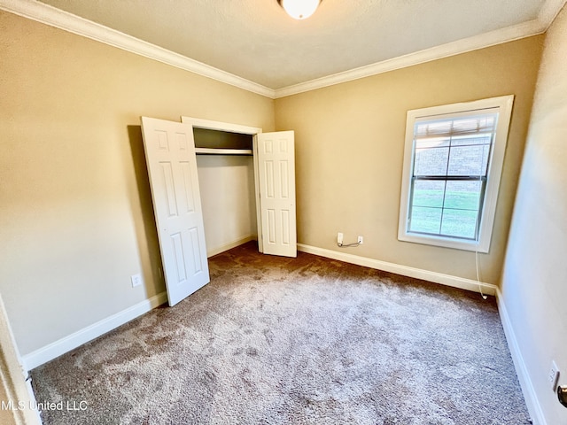 unfurnished bedroom featuring carpet floors, a closet, and ornamental molding