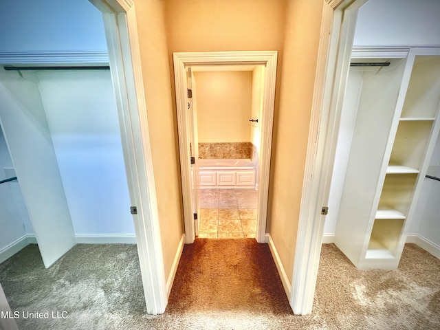 hall featuring carpet flooring