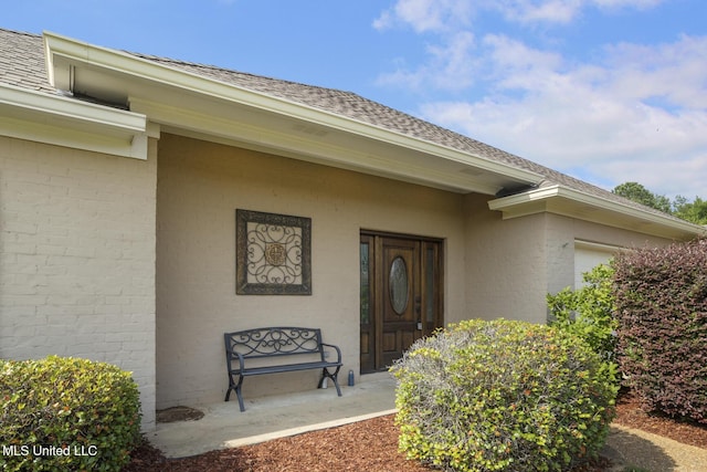 153 Regatta Dr, Brandon, MS 39047 - property entrance with a shingled roof and brick siding
