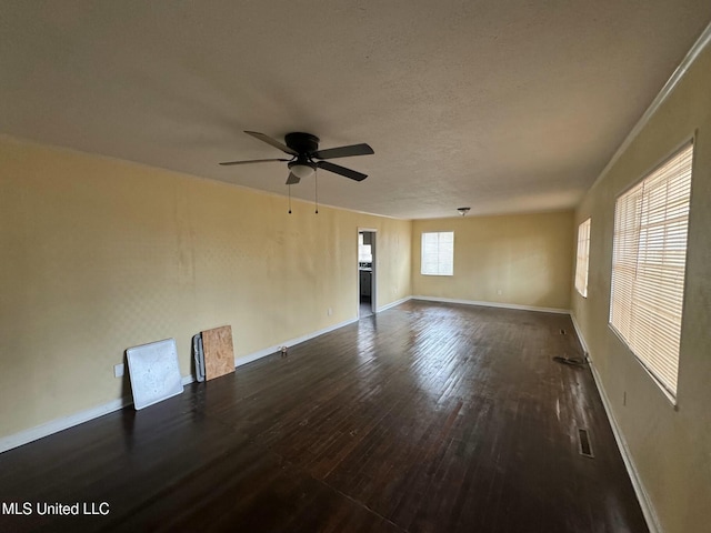 spare room featuring a textured ceiling, dark hardwood / wood-style floors, and ceiling fan