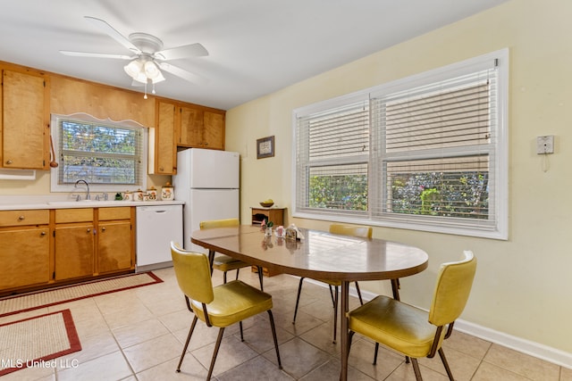 kitchen featuring light tile patterned floors, white appliances, ceiling fan, and sink