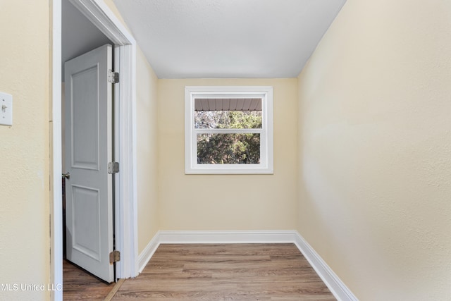 hall with hardwood / wood-style floors