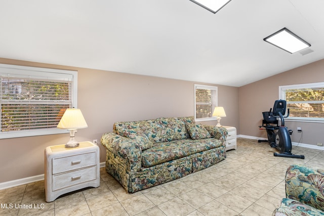 living room featuring a healthy amount of sunlight, light tile patterned flooring, and lofted ceiling