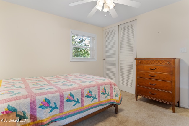 bedroom featuring ceiling fan, light colored carpet, and a closet