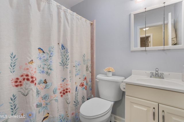 bathroom featuring a shower with shower curtain, vanity, and toilet