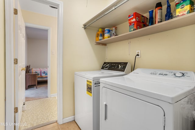 laundry room featuring separate washer and dryer and light tile patterned floors