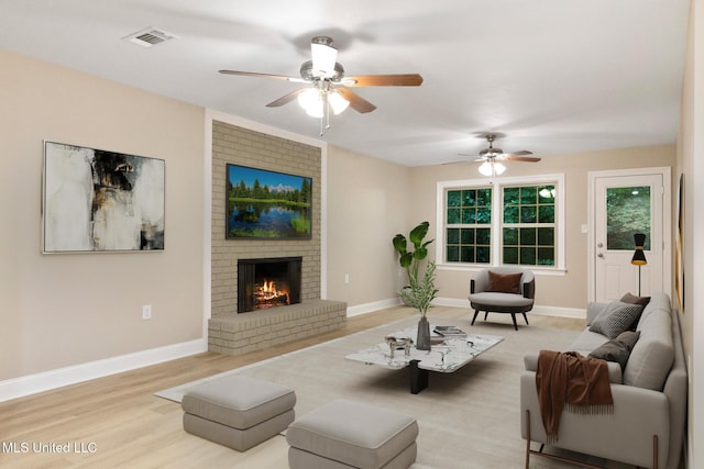 1304 Estelle St, Hattiesburg, MS 39402 - living area featuring a ceiling fan, a brick fireplace, and wood finished floors