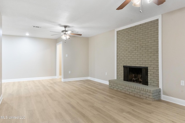 1304 Estelle St, Hattiesburg, MS 39402 - unfurnished living room with ceiling fan, light wood finished floors, and a fireplace