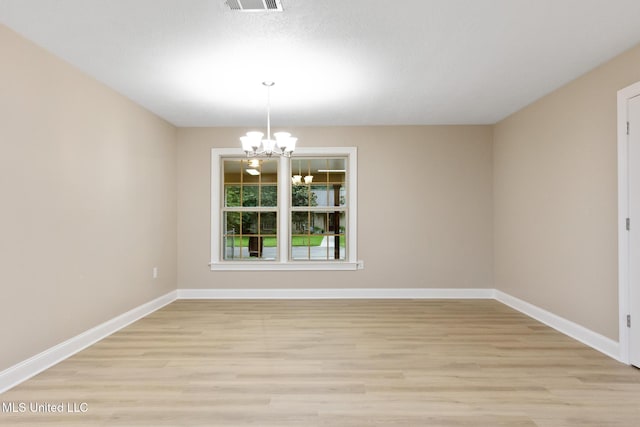 1304 Estelle St, Hattiesburg, MS 39402 - spare room with a chandelier and light wood-type flooring