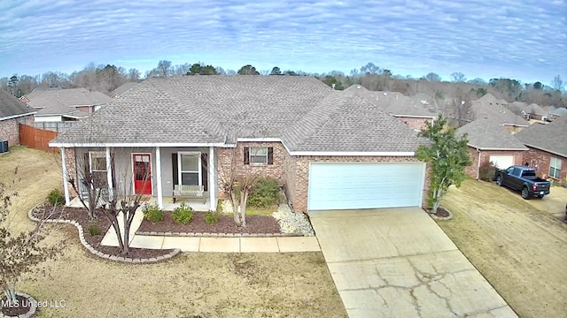 ranch-style home with a front yard, a garage, and central AC