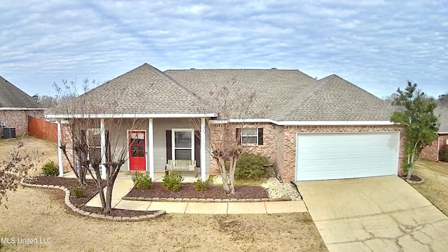 view of front of home featuring central AC, a garage, and a porch