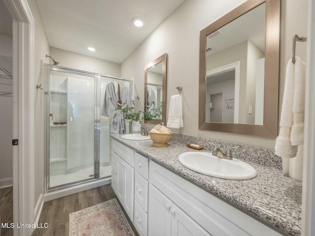 9668 W Oaklawn Rd, Biloxi, MS 39532 - full bathroom featuring double vanity, wood finished floors, and a shower stall