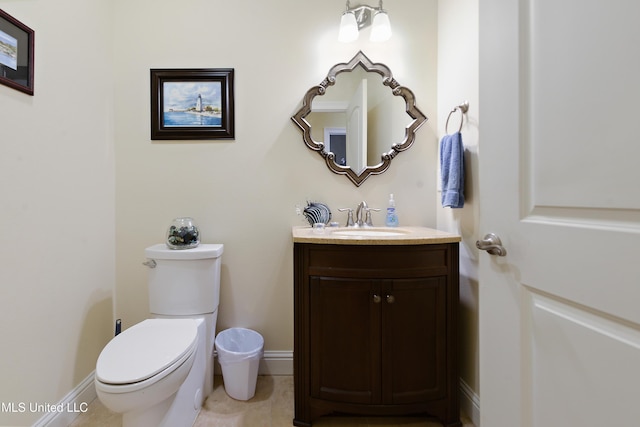 bathroom with baseboards, toilet, tile patterned flooring, and vanity