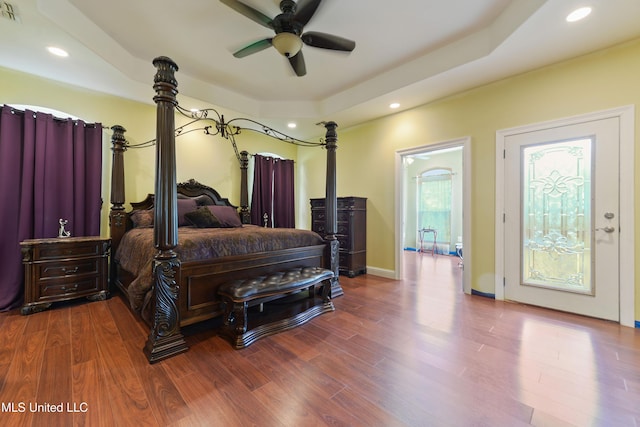 bedroom with visible vents, recessed lighting, wood finished floors, and a raised ceiling