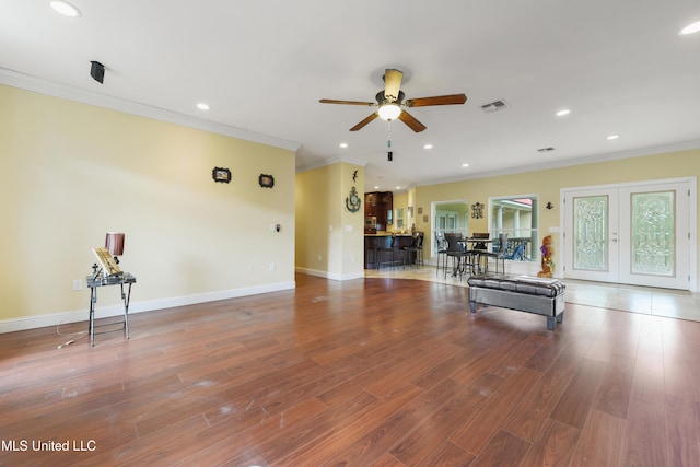 unfurnished living room with visible vents, recessed lighting, ornamental molding, wood finished floors, and a ceiling fan