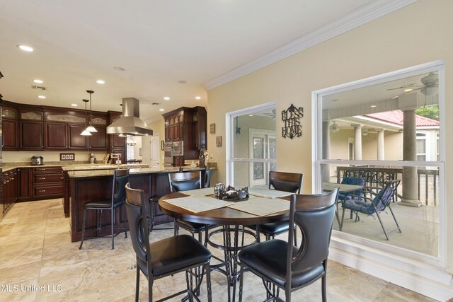 dining space with ornamental molding and recessed lighting
