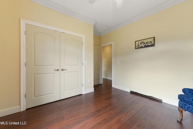 unfurnished bedroom with dark wood-type flooring, crown molding, and baseboards