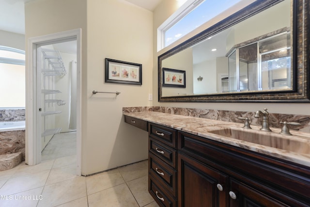full bathroom featuring tile patterned floors, walk in shower, a bath, and vanity