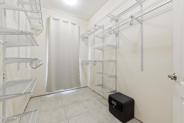 spacious closet featuring tile patterned floors