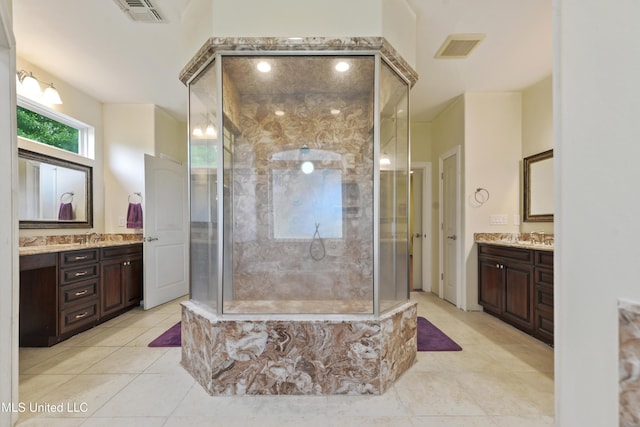 bathroom featuring tile patterned flooring, visible vents, a walk in shower, and vanity