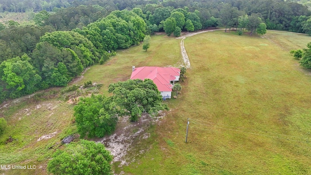 bird's eye view with a wooded view