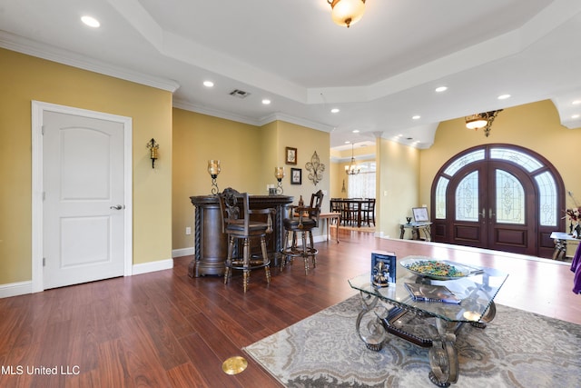 living area featuring a raised ceiling, recessed lighting, visible vents, and french doors