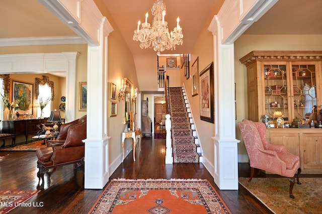 204 Arlington Ave, Natchez, MS 39120 - foyer entrance featuring ornate columns, dark wood-style floors, stairway, and a chandelier