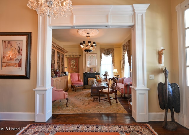 204 Arlington Ave, Natchez, MS 39120 - living area featuring a chandelier, decorative columns, and dark wood finished floors