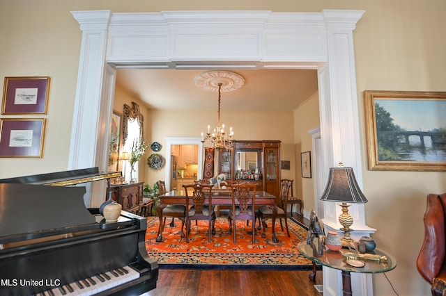 204 Arlington Ave, Natchez, MS 39120 - dining room with a chandelier and dark wood-style floors