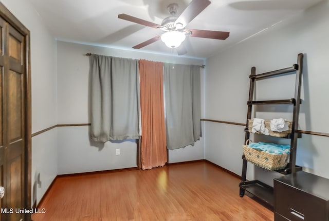 2213 N St, Gulfport, MS 39507 - unfurnished bedroom featuring wood finished floors, baseboards, and ceiling fan