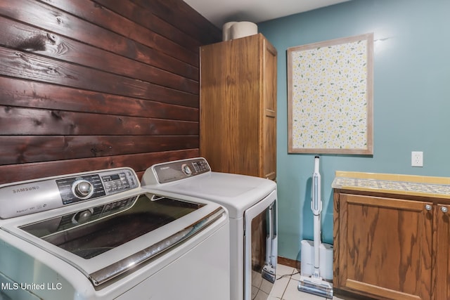 2213 N St, Gulfport, MS 39507 - laundry area featuring washing machine and dryer, cabinet space, and light tile patterned floors