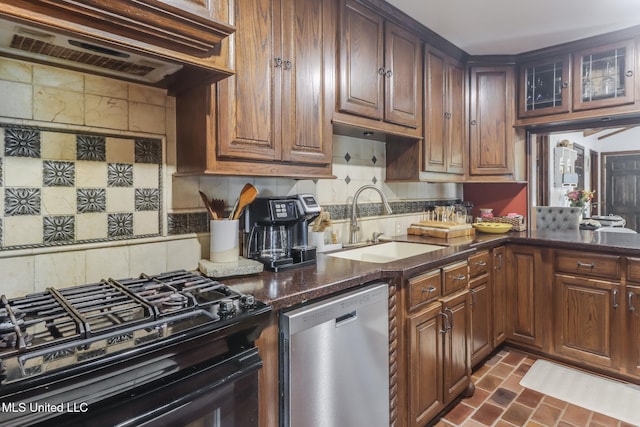 2213 N St, Gulfport, MS 39507 - kitchen featuring stainless steel dishwasher, black range with gas stovetop, extractor fan, a sink, and tasteful backsplash