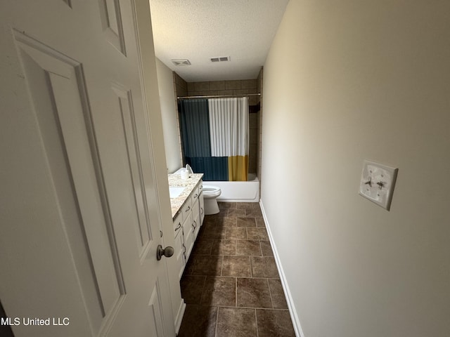 bathroom featuring visible vents, toilet, a textured ceiling, vanity, and baseboards