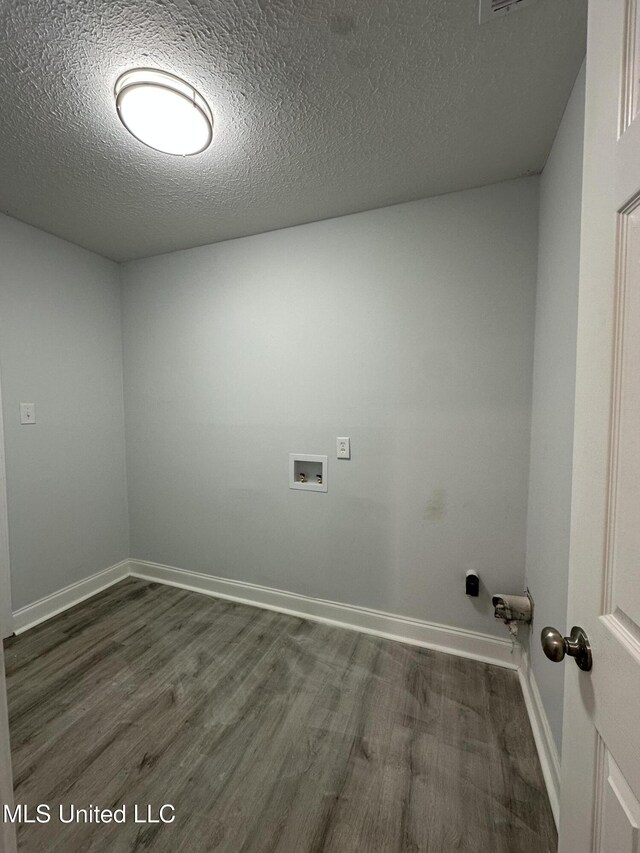 clothes washing area featuring hookup for a washing machine, a textured ceiling, and dark wood-type flooring