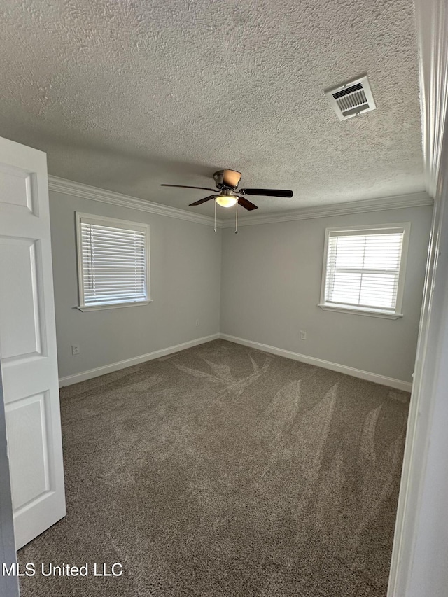 carpeted spare room with ceiling fan and ornamental molding