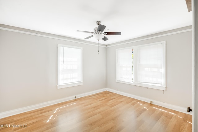 unfurnished room with ornamental molding, light wood-type flooring, and ceiling fan