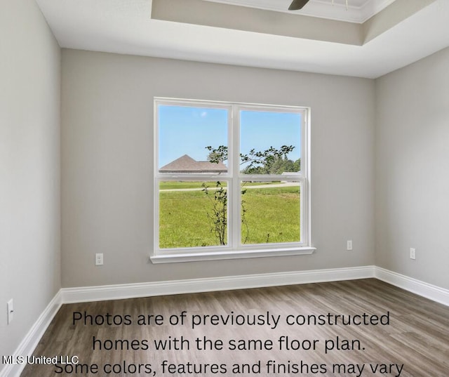 empty room with ceiling fan and hardwood / wood-style floors